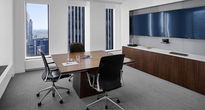 Breakout room highlighted by a wood surface MESA table with matching, glass top credenza